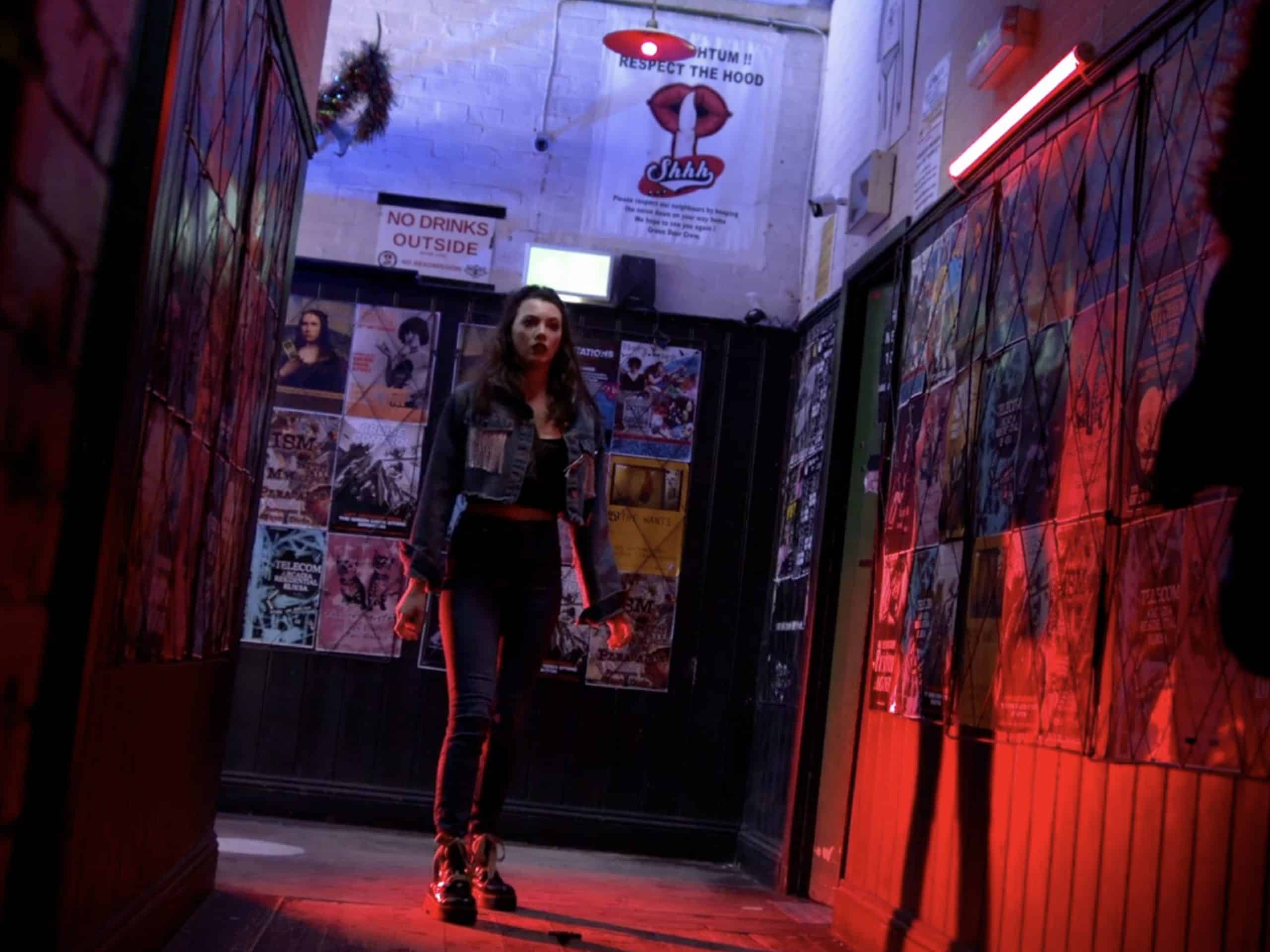 Ruby sings on stage in Brighton filming The Vile Bites in September 2025